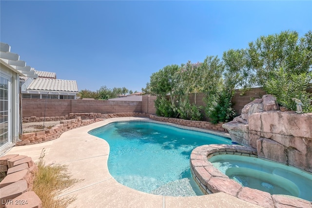 view of pool with an in ground hot tub