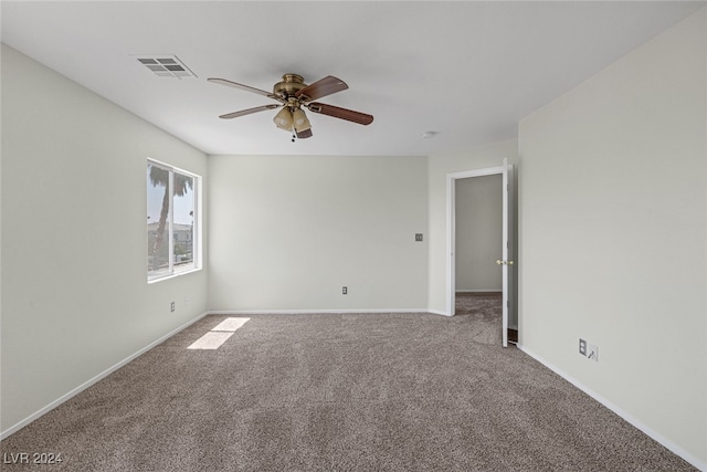 carpeted spare room with ceiling fan