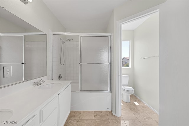 full bathroom featuring vanity, shower / bath combination with glass door, and toilet