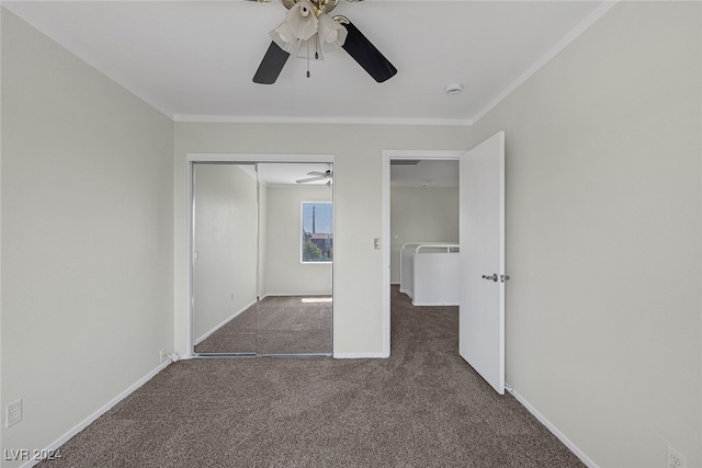 unfurnished bedroom with dark carpet, crown molding, and ceiling fan