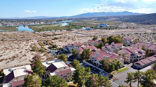 drone / aerial view featuring a water and mountain view