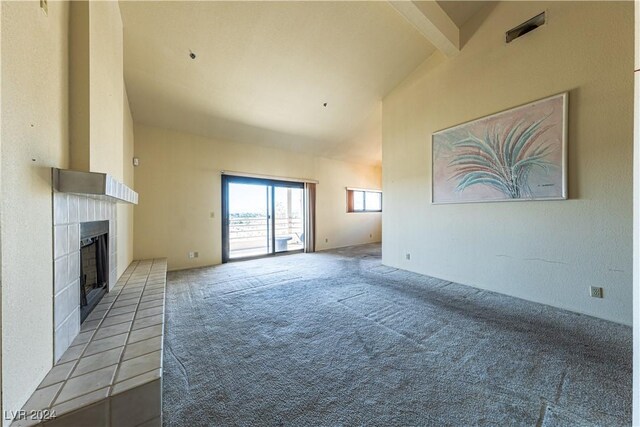 unfurnished living room featuring a fireplace, light carpet, and lofted ceiling