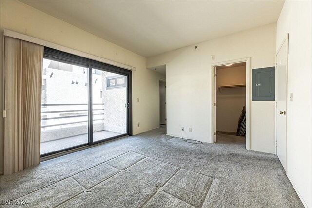 spare room with electric panel and light colored carpet