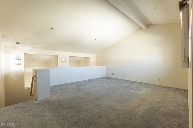 carpeted spare room with vaulted ceiling with beams