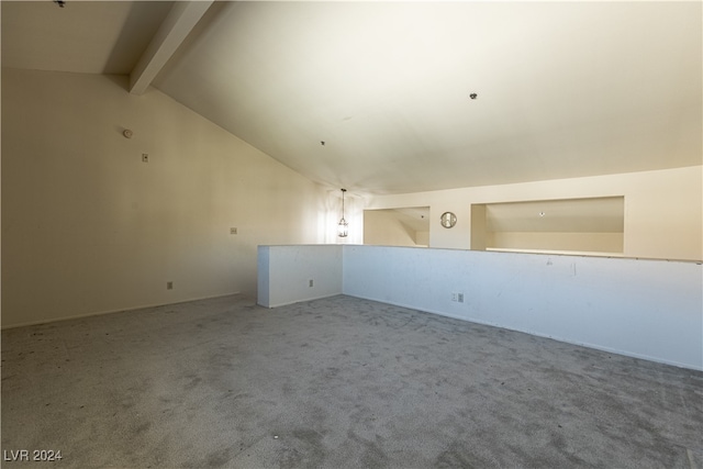 carpeted spare room with lofted ceiling with beams