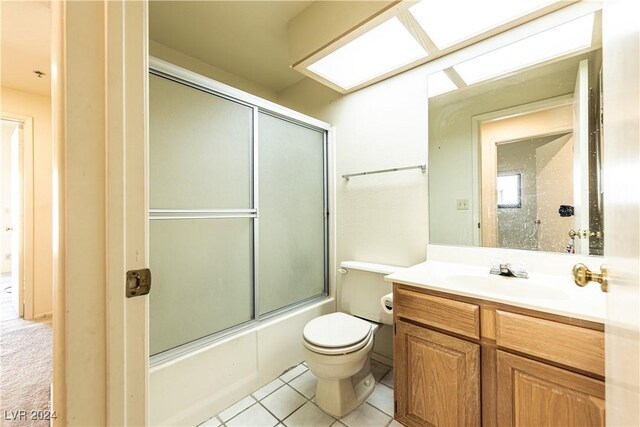 full bathroom with vanity, toilet, tile patterned flooring, and enclosed tub / shower combo