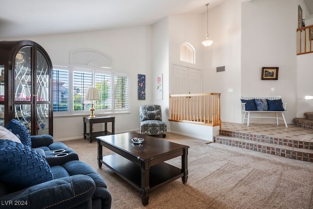 carpeted living room featuring a high ceiling