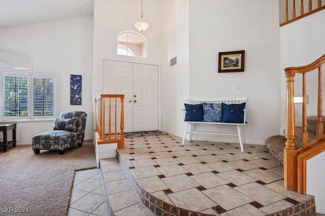 foyer featuring high vaulted ceiling