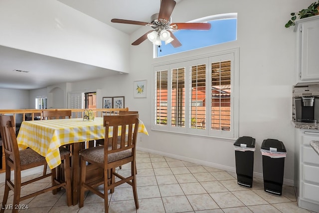 dining area featuring light tile patterned flooring, sink, and ceiling fan