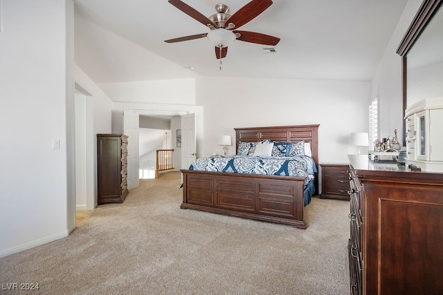 carpeted bedroom with vaulted ceiling and ceiling fan