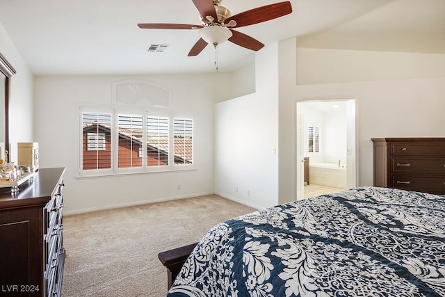 bedroom featuring lofted ceiling, light colored carpet, ceiling fan, and ensuite bathroom