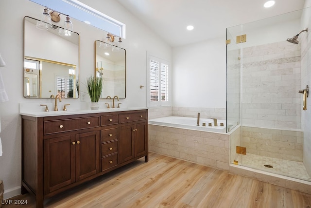 bathroom with lofted ceiling, vanity, hardwood / wood-style floors, and shower with separate bathtub