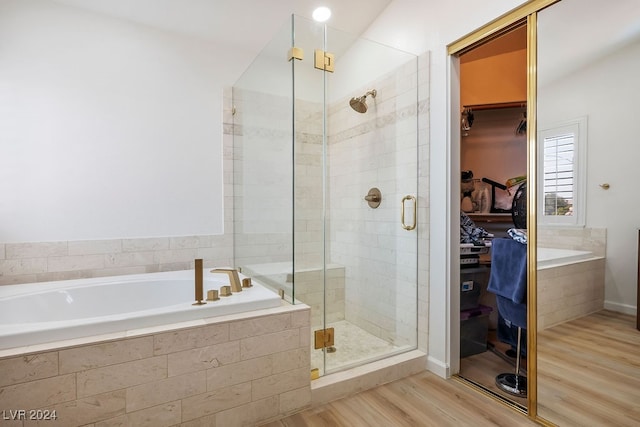 bathroom with plus walk in shower and hardwood / wood-style floors