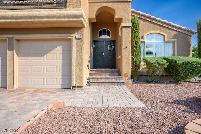 view of exterior entry featuring a garage