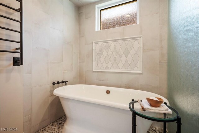 bathroom featuring a washtub and tile patterned flooring