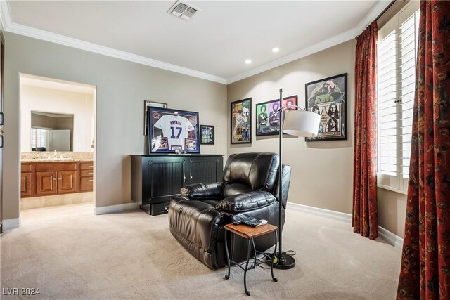 sitting room featuring light colored carpet, a wealth of natural light, and crown molding