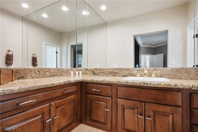 bathroom featuring crown molding and vanity