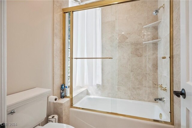 bathroom with toilet and enclosed tub / shower combo