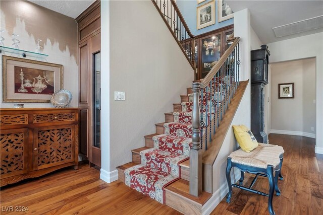 stairs with hardwood / wood-style floors