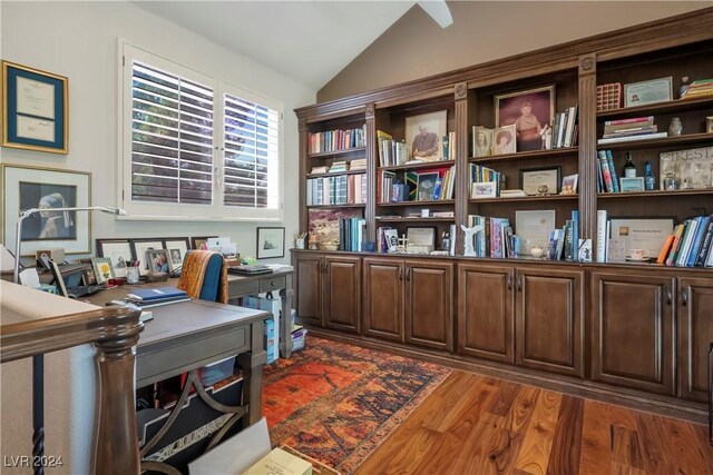 office space featuring dark wood-type flooring and vaulted ceiling