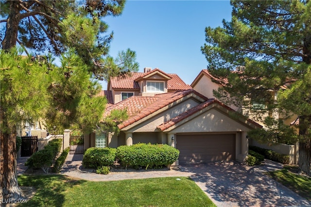 mediterranean / spanish house with a garage