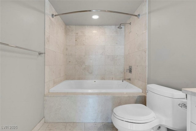 full bathroom featuring toilet, vanity, tiled shower / bath combo, and tile patterned floors