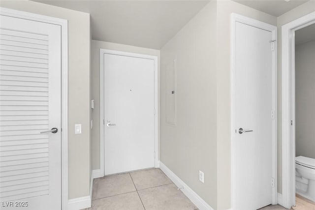 hall featuring light tile patterned flooring