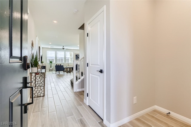 corridor with light hardwood / wood-style floors