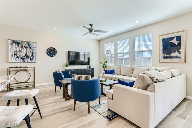 living room with ceiling fan and light wood-type flooring