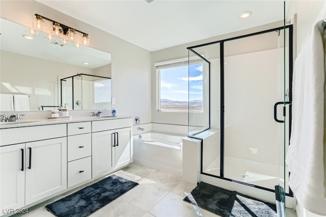 bathroom with tile patterned flooring, vanity, and plus walk in shower