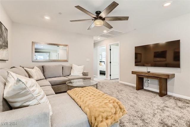 living room with ceiling fan and light colored carpet