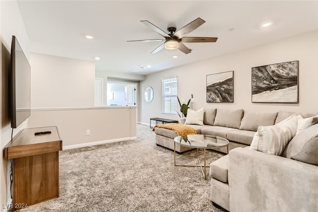 carpeted living room featuring ceiling fan