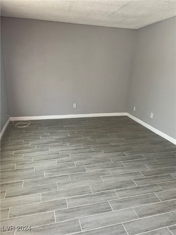 unfurnished room featuring a textured ceiling