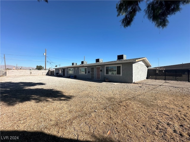 back of property featuring cooling unit