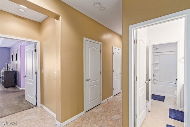 corridor featuring light tile patterned floors