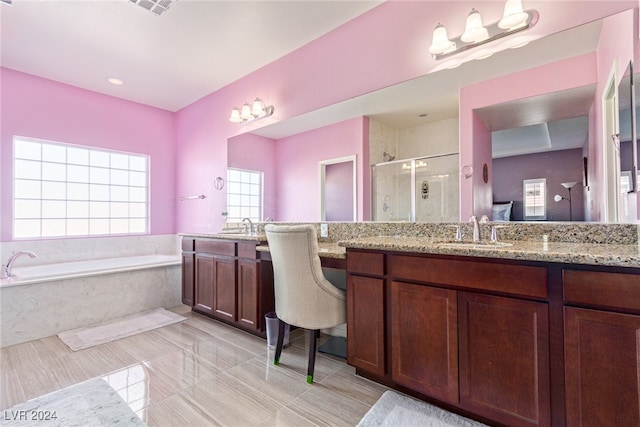 bathroom featuring vanity and independent shower and bath