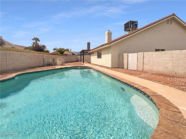 view of swimming pool with central AC unit