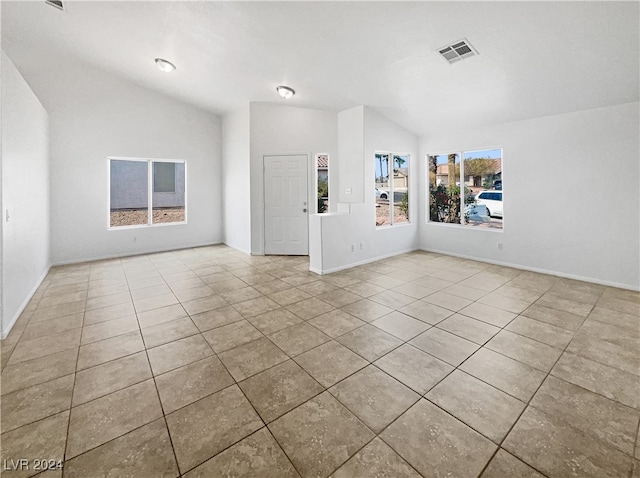 interior space featuring lofted ceiling and light tile patterned floors