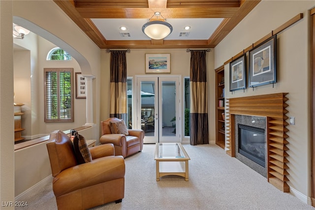 living room featuring french doors, a premium fireplace, and light carpet