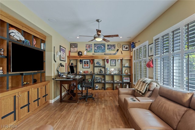 living room featuring light hardwood / wood-style flooring and ceiling fan