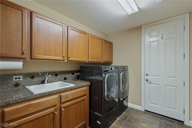 laundry area featuring cabinets, sink, and independent washer and dryer