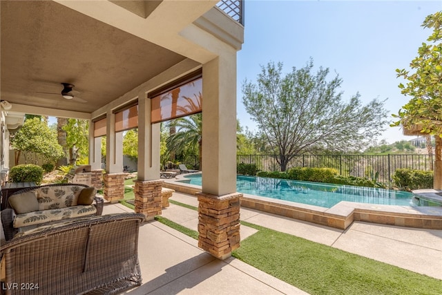 view of patio with ceiling fan and a fenced in pool