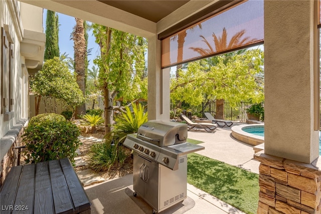 view of patio with a pool and grilling area