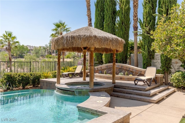 view of swimming pool featuring an in ground hot tub