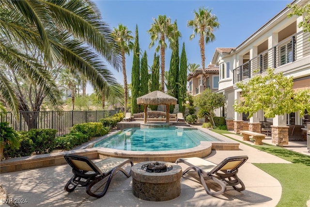 view of pool featuring an outdoor fire pit, a patio, and a gazebo