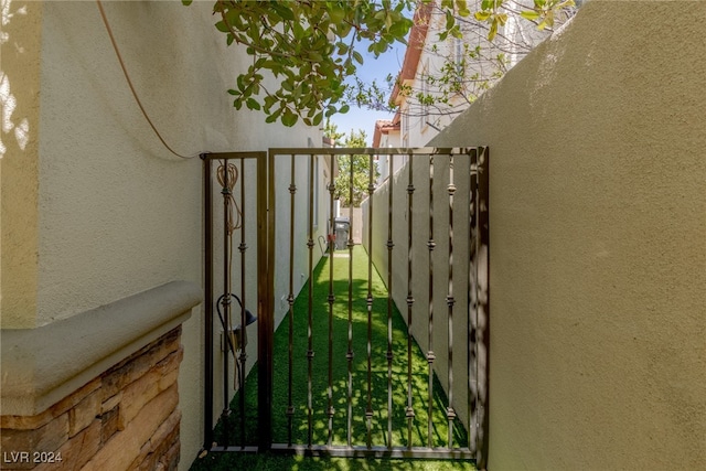 view of gate with a yard