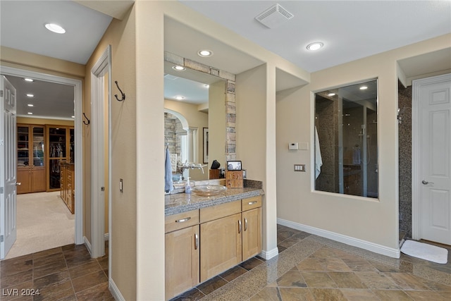 interior space with light brown cabinets and sink