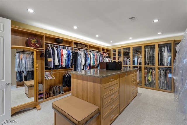 spacious closet with light carpet