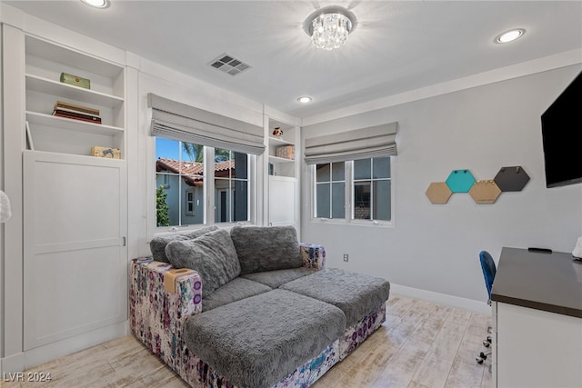 living room featuring a chandelier and light hardwood / wood-style floors