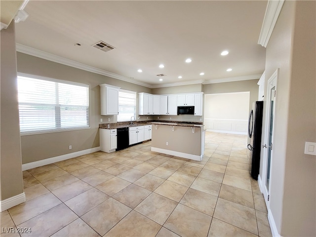 kitchen with black appliances, a kitchen island, crown molding, and white cabinets